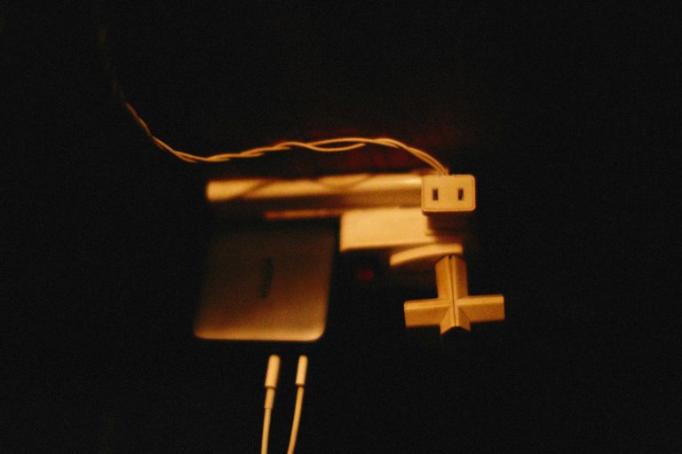 a computer mouse connected to a laptop in the dark
